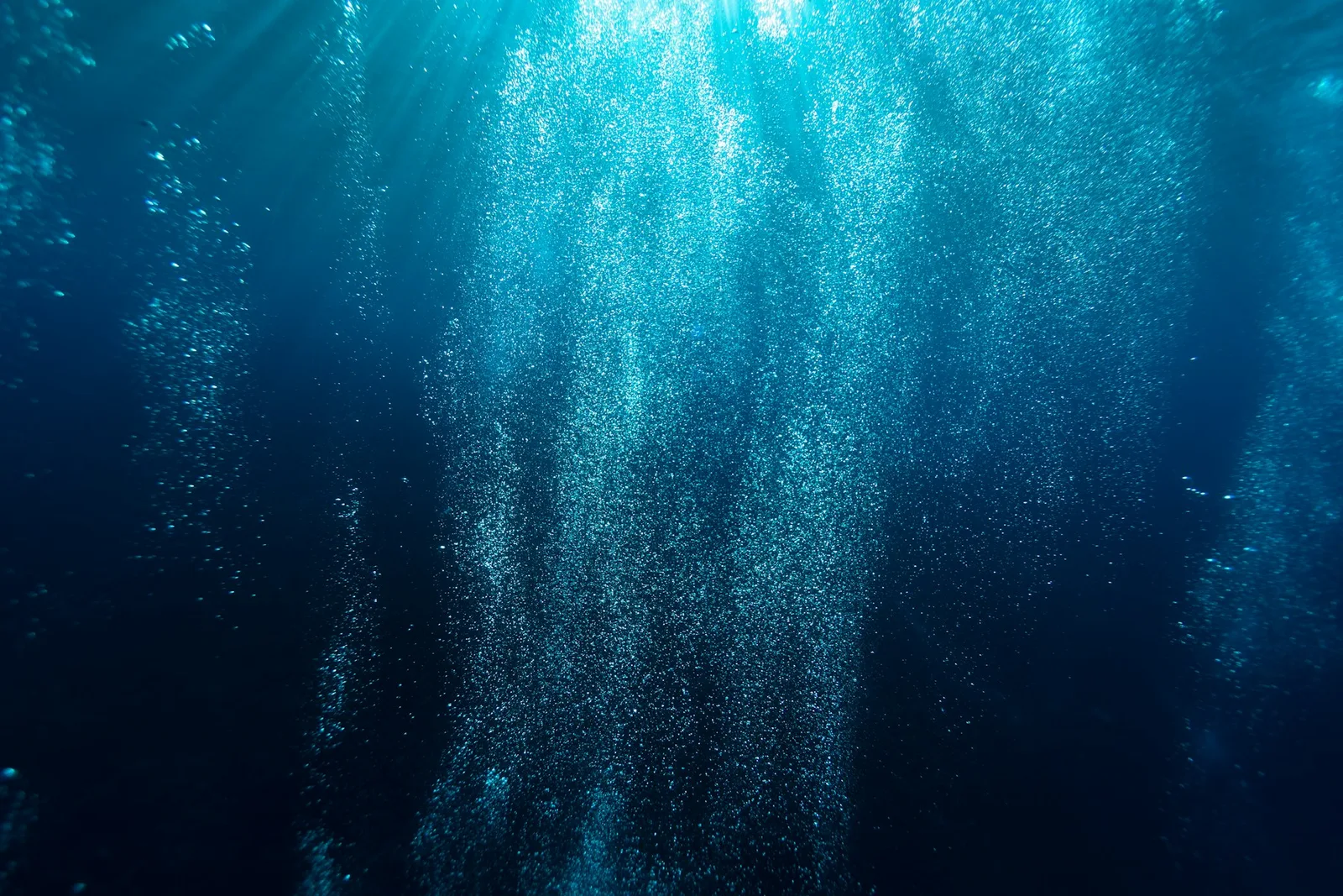 Light rays cutting through deep blue water