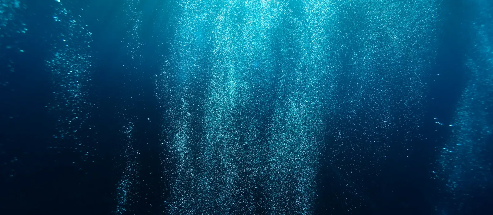 Light rays cutting through deep blue water