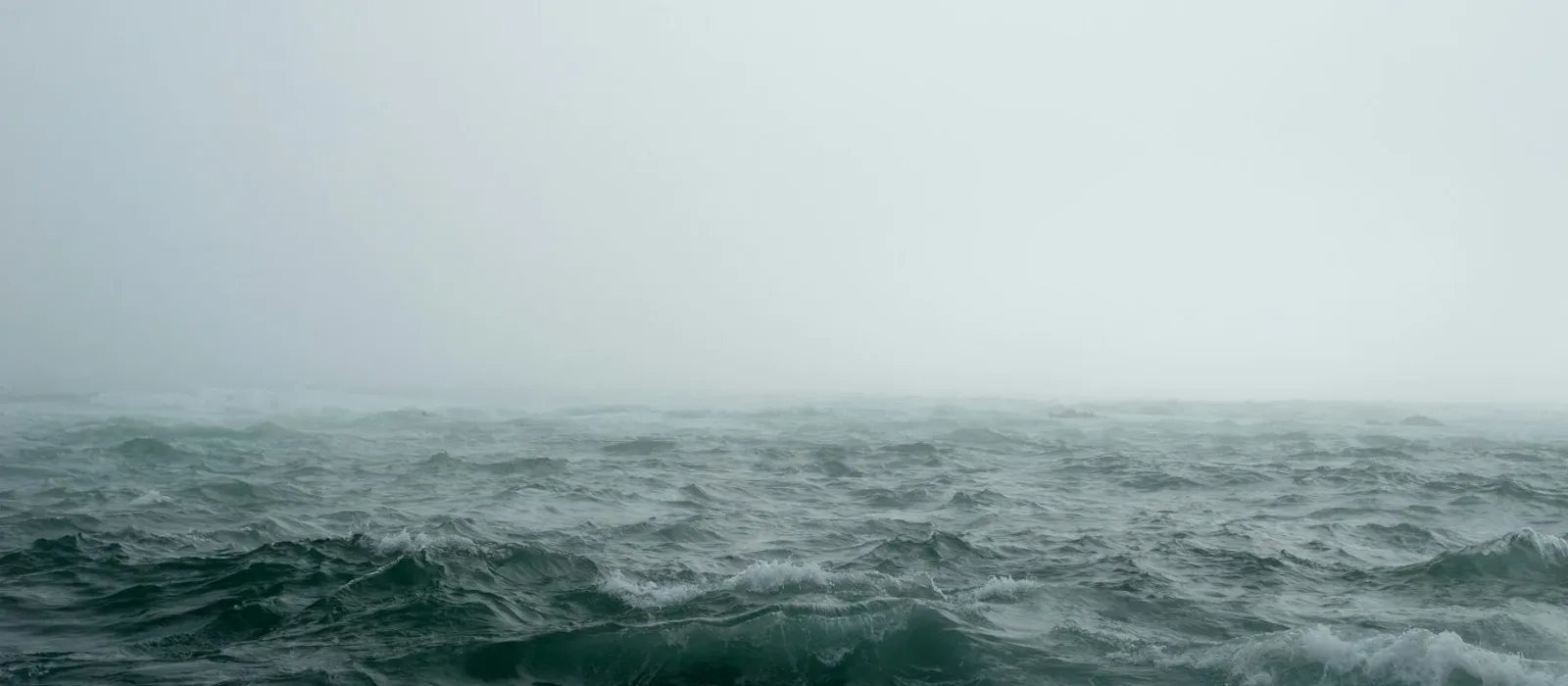 A dark stormy sea under heavy clouds